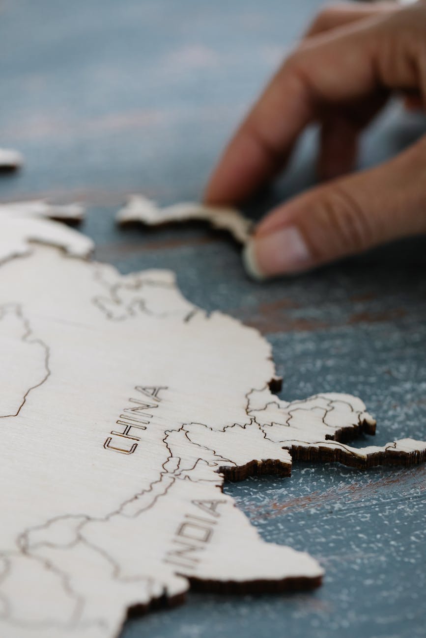 person assembling wooden world map